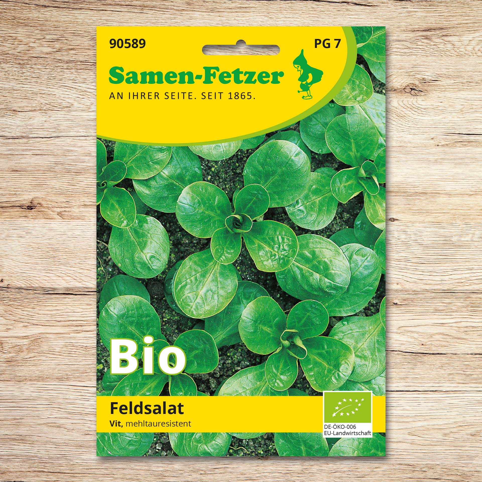 Saatgutpackung Bio Feldsalat Vit von Samen-Fetzer mit dunkelgrünen, rundblättrigen Feldsalatpflanzen, mehltauresistent und ideal für Herbst- und Winterernte im Freiland sowie unter Glas oder Folie