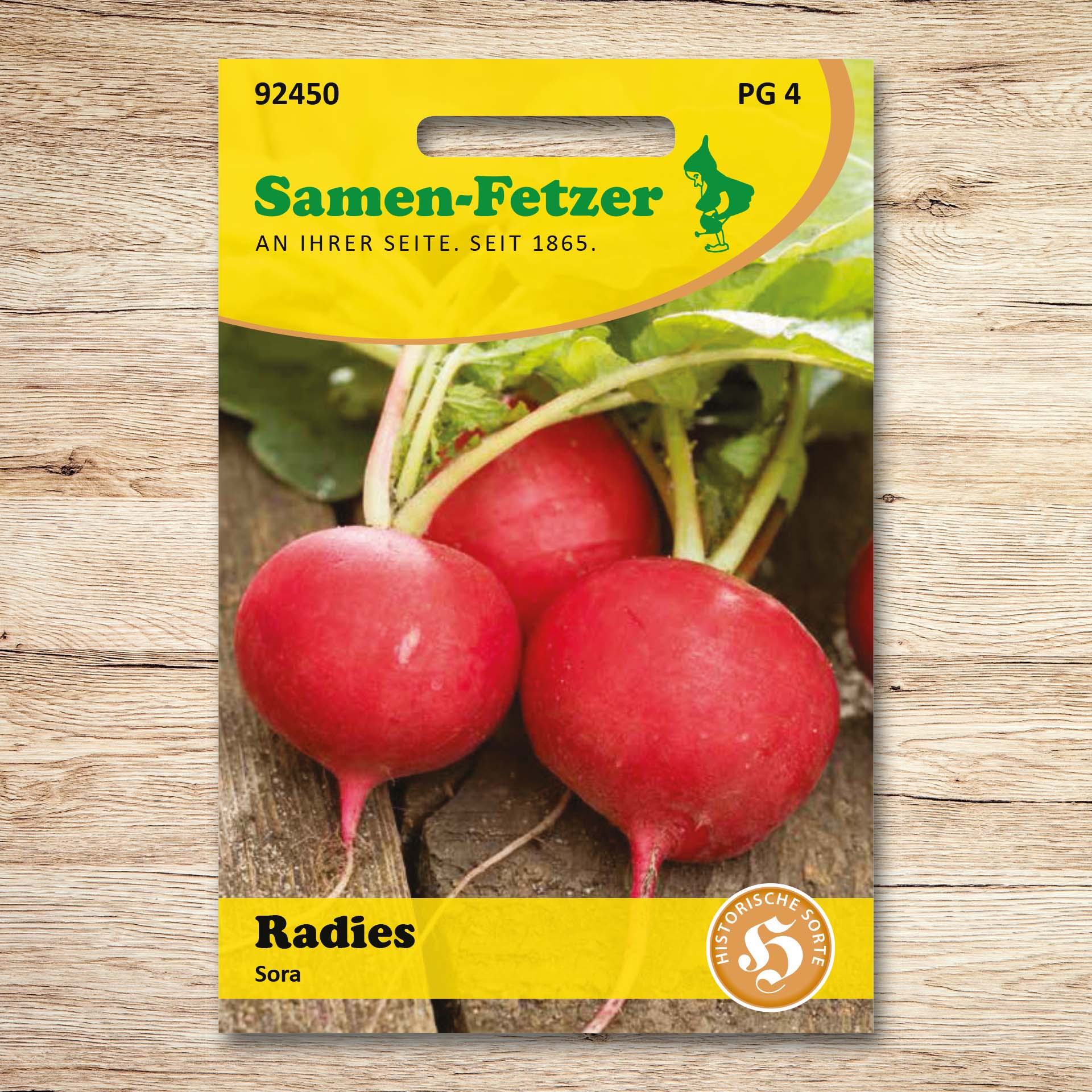 Abgebildet ist die Saatgutpackung Radies Sora von Samen-Fetzer mit roten Radieschen – Teil des Samen-Sortiments Fetzers Zweite Ernte Starter Set für die Sommeraussaat auf freien Beetflächen.